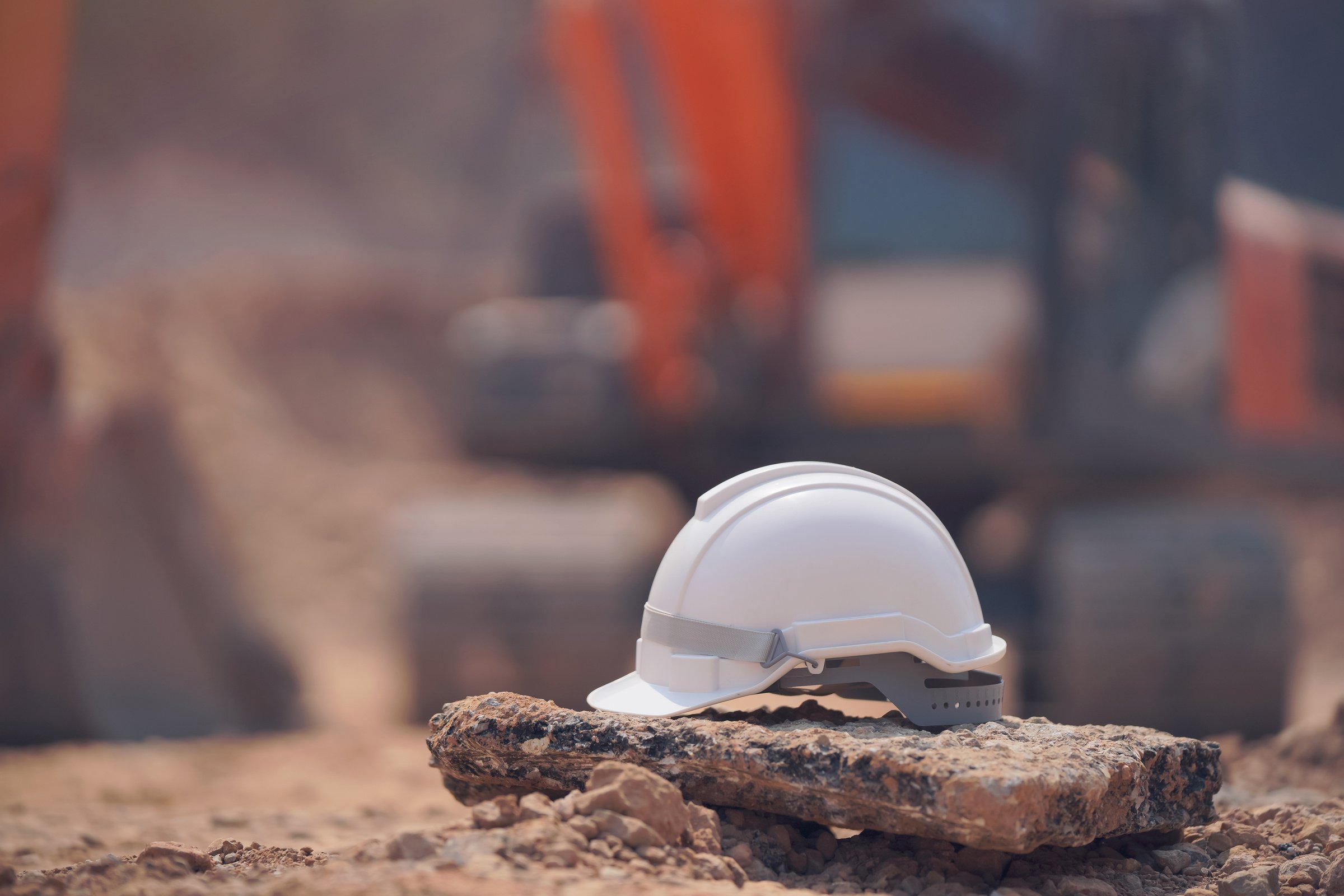 Safety helmet at construction site, road construction site background, safety concept